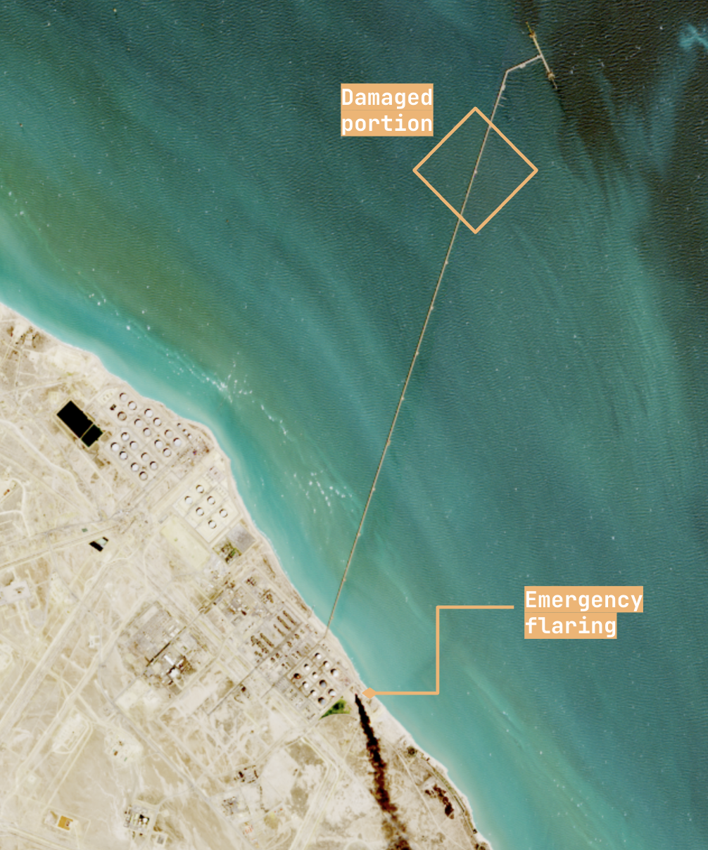 Juaymah NGL terminal — the export trestle running offshore from the tank farm, with the damaged span offshore and onshore emergency flaring both visible.